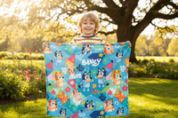 kid holding up a bluey the cartoon blanket